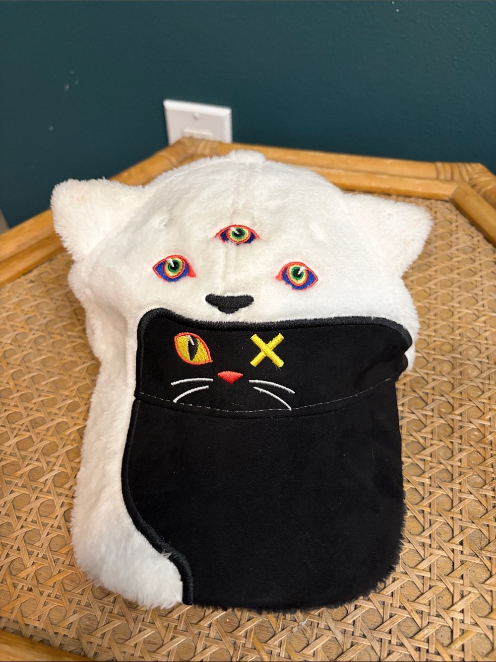 Plush White Kids Hat with Triple Rainbow Eyes and Black Cat Pocket